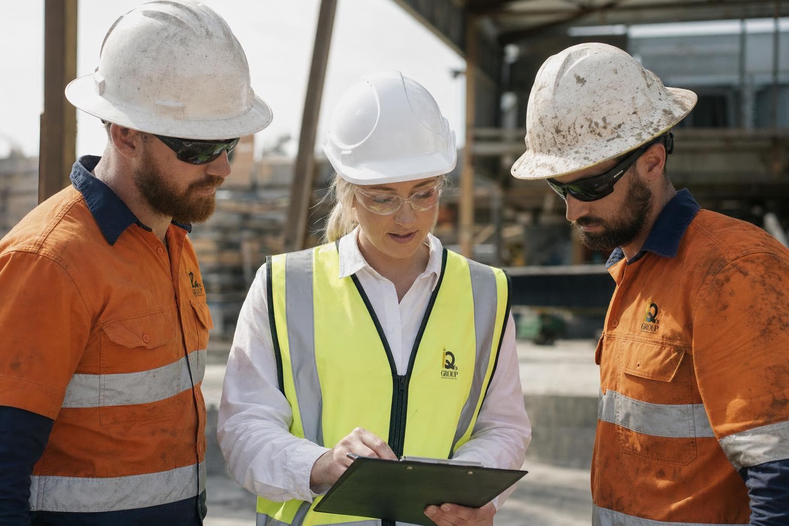 Safety officer reviewing a checklist with workers on site